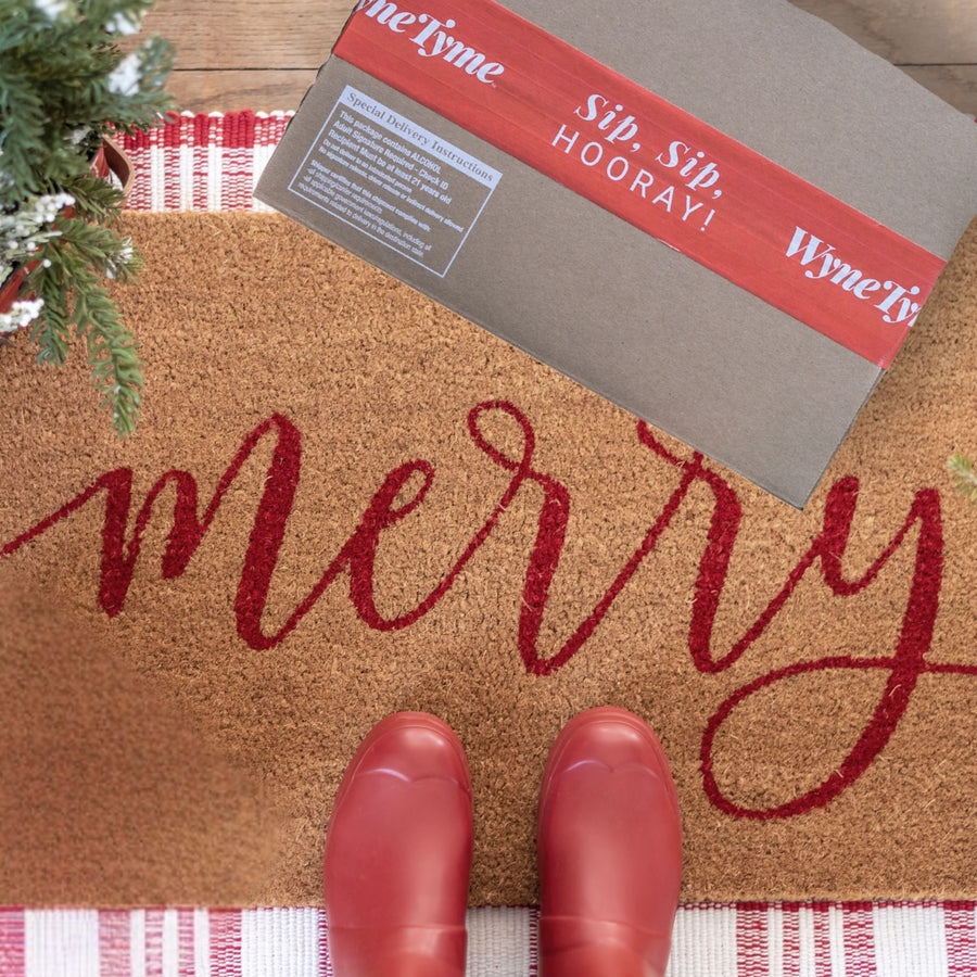 WyneTyme box delivery with "Merry" Welcome Mat